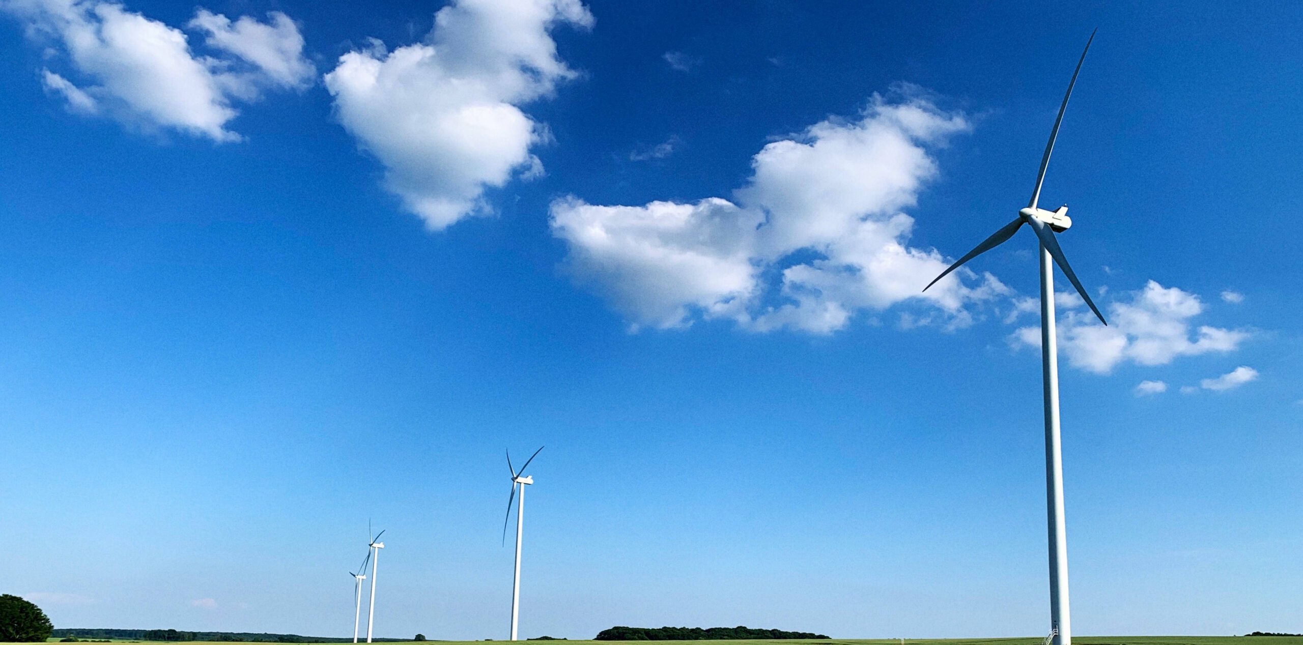 Wind turbines against a blue sky (Photo by Serge Le Strat)